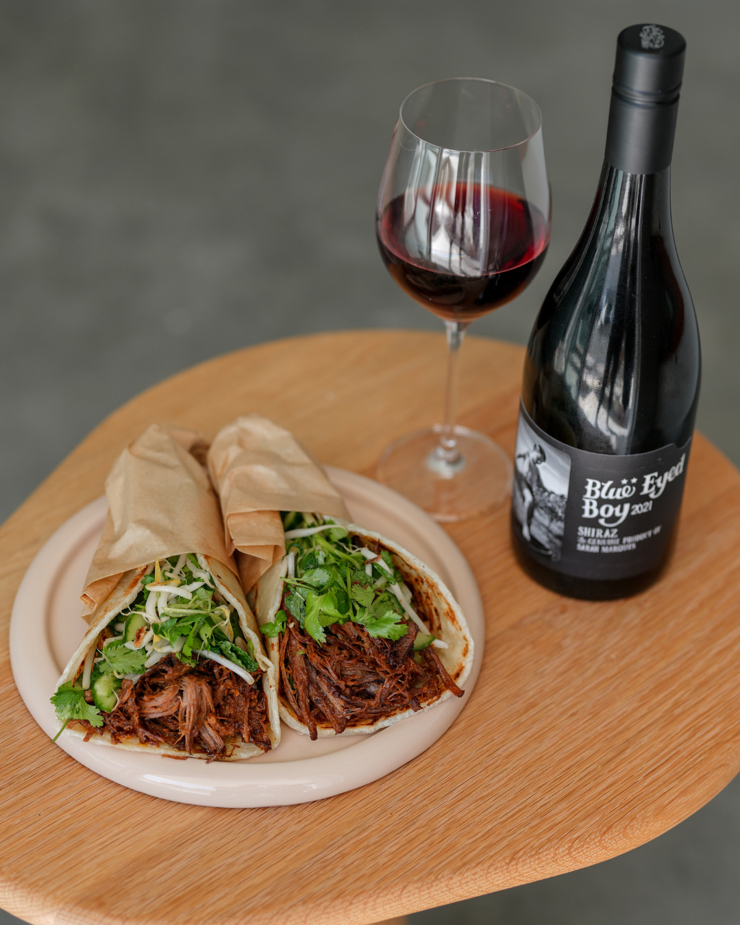 Beef brisket hawker roll served with a glass of MollyDooker Wines Blue Eyed Boy Shiraz
